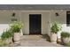 Charming front entrance with stylish door, elegant planters, and modern outdoor lighting at 204 Canyon Dr, Las Vegas, NV 89107