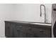 A modern laundry room featuring dark cabinets with stone countertops at 204 Canyon Dr, Las Vegas, NV 89107