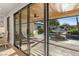 Modern living space featuring sliding glass doors leading to a pool and outdoor entertaining area at 204 Canyon Dr, Las Vegas, NV 89107