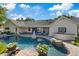 Sparkling backyard pool with rock accents, patio seating, and a built-in outdoor grill under sunny skies at 204 Canyon Dr, Las Vegas, NV 89107