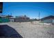 A gravel backyard with a chain link fence at 215 Zinc St, Henderson, NV 89015