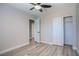 This bedroom offers laminate flooring, a ceiling fan, and a closet for ample storage at 215 Zinc St, Henderson, NV 89015