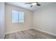 The bedroom features laminate flooring, a ceiling fan, and a window, creating a clean, contemporary space at 215 Zinc St, Henderson, NV 89015