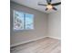 The bedroom features laminate flooring, a modern ceiling fan, and a window, creating a clean, contemporary space at 215 Zinc St, Henderson, NV 89015