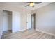 Bedroom with wood-look floors, ceiling fan, closet and white trim at 215 Zinc St, Henderson, NV 89015