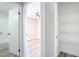 This hallway leads to a modern bedroom with laminate flooring, and also features convenient built-in shelving for storage at 215 Zinc St, Henderson, NV 89015