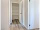 Hallway leading to closet with storage shelves and a white paneled door at 215 Zinc St, Henderson, NV 89015