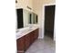 Bathroom featuring double sinks with a granite countertop and custom wood cabinets at 2175 Clearwater Lake Dr, Henderson, NV 89044