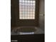Bathroom featuring bright tile window over a soaking tub at 2175 Clearwater Lake Dr, Henderson, NV 89044