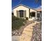Inviting home entrance with a decorative stone walkway and iron gate at 2175 Clearwater Lake Dr, Henderson, NV 89044