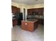 Stylish kitchen boasts stainless appliances, center island, and dark wood cabinets at 2175 Clearwater Lake Dr, Henderson, NV 89044