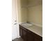 The laundry room features a sink with cabinets beneath it and a wire shelf installed above it at 2175 Clearwater Lake Dr, Henderson, NV 89044