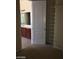 Walk-in closet leading to a bathroom with lots of adjustable metal shelving at 2175 Clearwater Lake Dr, Henderson, NV 89044