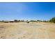 Large open backyard featuring desert landscaping with a vehicle in the background at 2251 Bridger St, Pahrump, NV 89048