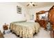 Cozy bedroom features a ceiling fan, carpet, and a dark wood dresser at 2251 Bridger St, Pahrump, NV 89048