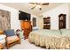 Comfortable bedroom features a ceiling fan, a tv, and an assortment of wooden furniture at 2251 Bridger St, Pahrump, NV 89048