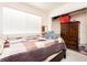 Bright bedroom features a large window, a closet, and dark wood dresser at 2251 Bridger St, Pahrump, NV 89048