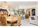 Inviting dining room featuring a large wooden table and chairs, with views into the kitchen area at 2251 Bridger St, Pahrump, NV 89048