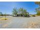 Single-story home with gravel yard and a mix of desert vegetation and landscaping at 2251 Bridger St, Pahrump, NV 89048