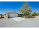Charming single-story home with a two-car garage and desert landscaping on a sunny day at 2251 Bridger St, Pahrump, NV 89048