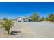 Inviting single-story home with gravel landscaping and mature trees on a spacious lot at 2251 Bridger St, Pahrump, NV 89048