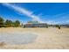 Home with solar panels amidst a desert landscape, under a bright, partly cloudy sky at 2251 Bridger St, Pahrump, NV 89048