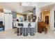 Kitchen island features a tile countertop, white bar stools, and pendant lighting at 2251 Bridger St, Pahrump, NV 89048