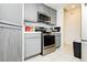 Efficient kitchen featuring stainless steel appliances, gray cabinets, and tile flooring at 2251 Bridger St, Pahrump, NV 89048