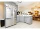 Spacious kitchen featuring a stainless steel refrigerator, gray cabinets, and tile flooring at 2251 Bridger St, Pahrump, NV 89048