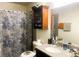 Well-lit bathroom with a granite vanity, wooden cabinet, and patterned shower curtain at 2451 N Rainbow Blvd # 2073, Las Vegas, NV 89108