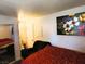 Cozy bedroom featuring a large bed, floral art, and a mirrored closet for ample storage at 2451 N Rainbow Blvd # 2073, Las Vegas, NV 89108
