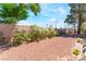 Landscaped backyard features a brick wall, plants, trees, and decorative rock, offering privacy at 2851 S Valley View Blvd # 1071, Las Vegas, NV 89102