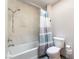 Bathroom featuring tub/shower combo with tiled surround, toilet and gray tile floors at 2851 S Valley View Blvd # 1071, Las Vegas, NV 89102