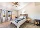 Bedroom featuring large window, dresser, and a queen bed with a blue blanket at 2851 S Valley View Blvd # 1071, Las Vegas, NV 89102