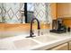 Kitchen sink with modern faucet, white countertops, and a window providing natural light at 2851 S Valley View Blvd # 1071, Las Vegas, NV 89102
