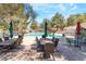 Community pool surrounded by patio furniture and mature landscaping at 2851 S Valley View Blvd # 1071, Las Vegas, NV 89102