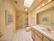 Bright bathroom with a glass-enclosed shower, white tile floor, a spacious vanity, and framed artwork at 2851 S Valley View Blvd # 1199, Las Vegas, NV 89102