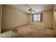 A spacious bedroom with a ceiling fan, carpeted floors, and a large window to fill the space with natural light at 2851 S Valley View Blvd # 1199, Las Vegas, NV 89102