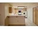 Bright kitchen featuring wood cabinets, tile floors, breakfast bar, and modern appliances at 2851 S Valley View Blvd # 1199, Las Vegas, NV 89102
