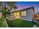 Spacious backyard featuring synthetic grass, exterior patio, and desert landscaping at 2921 Guillemot Ave, North Las Vegas, NV 89084