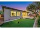 Beautiful backyard featuring a putting green, desert landscaping, and covered patio at 2921 Guillemot Ave, North Las Vegas, NV 89084