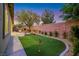 Backyard putting green surrounded by artificial turf and desert landscaping at 2921 Guillemot Ave, North Las Vegas, NV 89084