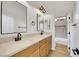 Modern bathroom featuring double sinks with wood cabinets and stone countertops at 2921 Guillemot Ave, North Las Vegas, NV 89084