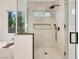 Modern bathroom featuring a glass shower with a rainfall shower head and a view from the window at 2921 Guillemot Ave, North Las Vegas, NV 89084