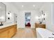 Bright bathroom with double sink vanity, bathtub and a view to the main bedroom at 2921 Guillemot Ave, North Las Vegas, NV 89084