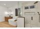 Modern bathroom featuring a soaking tub, shower, and double sink vanity with wood cabinets at 2921 Guillemot Ave, North Las Vegas, NV 89084