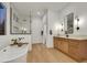 Bright bathroom showcasing a soaking tub, double sink vanity, and glass shower at 2921 Guillemot Ave, North Las Vegas, NV 89084