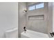 Stylish bathroom featuring a bright white tiled shower-tub and modern fixtures at 2921 Guillemot Ave, North Las Vegas, NV 89084