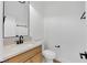 Elegant half bathroom featuring a modern vanity with a light countertop and dark fixtures at 2921 Guillemot Ave, North Las Vegas, NV 89084