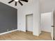 Neutral bedroom with dark accent wall, ceiling fan, wood-look floors, and closet at 2921 Guillemot Ave, North Las Vegas, NV 89084